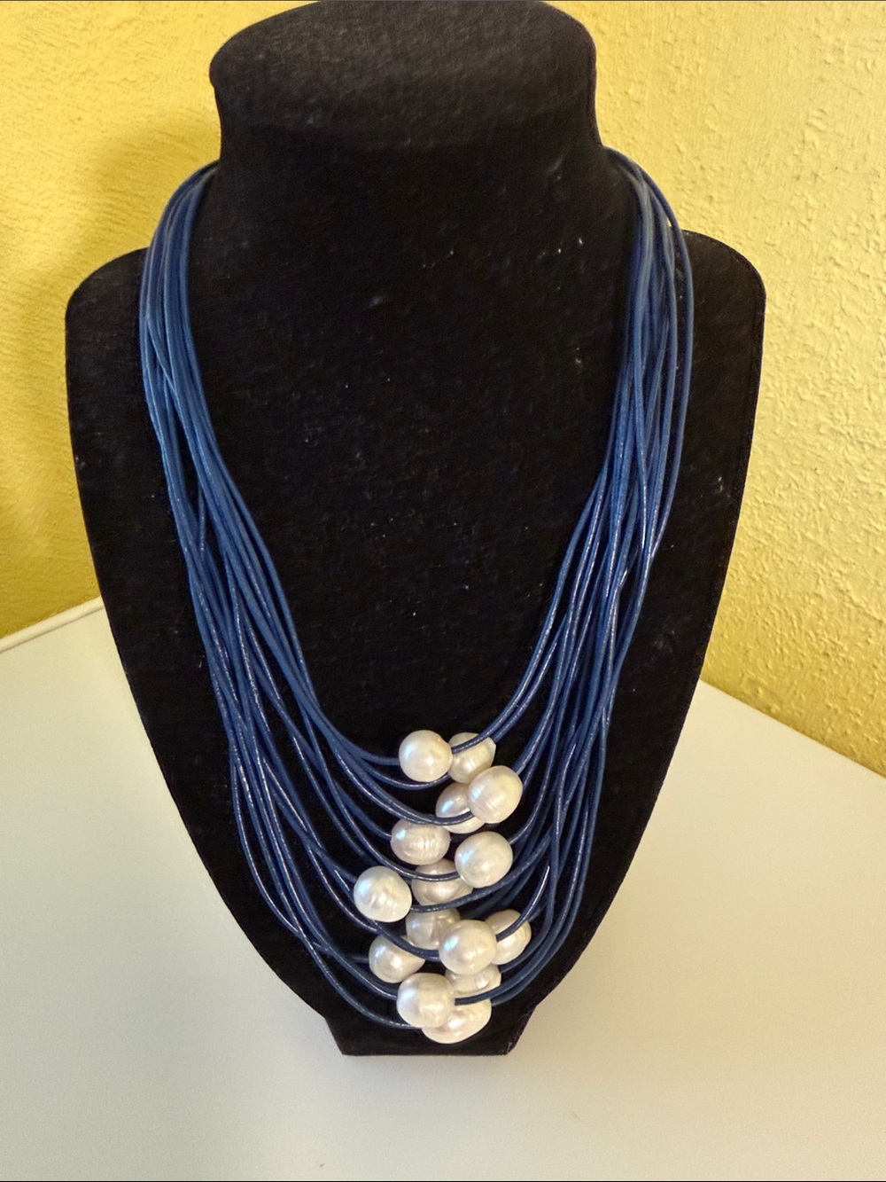 Freshwater Pearl necklace on blue leather cords.
